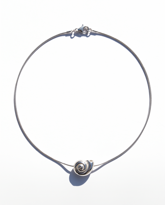 A thin silver wire choker necklace with a small spiral shell charm at the front, displayed on a clean white background.